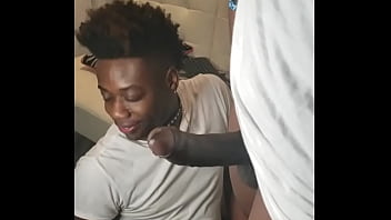 A black slave with a collar gets his face fucked by a fan